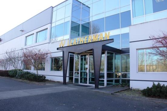 This is the entrance to Leatherman headquarters. Offices occupy a small area near the front of the 90,000 square-foot facility—most of which is factory. I wanted to show the entire building, but it’s 600 feet long and I could not get far enough back to get the whole thing into a single photo. You can 
see it here from the air; the entrance is the recessed area in the left third of the building. The very first Leatherman tools were produced by hand in a garage machine shop but when orders began to flow in Tim Leatherman and his business partner, Steve Berliner, built a facility on this site in 1983. The facility has since been expanded a couple of times.