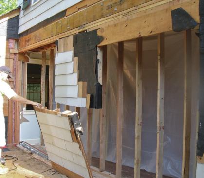 After hammering the bolts through both microlams and the steel and securing them with washers and nuts, we installed our joist hangers and then removed the remaining existing wall below the new beam.