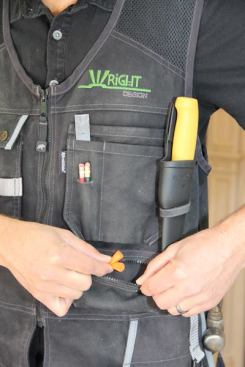 Just below the left chest pocket is a wide shallow zippered compartment. It’s a great place to store things you don’t want to lose. I keep extra foam ear plugs and ear buds for my mp3 player in there. Note the mesh fabric below the shoulders; it’s the same material as is on the back and is there to make the vest cooler to wear.