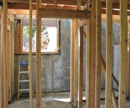 The retaining wall foundation adds needed living space where the building steps down the hillside.