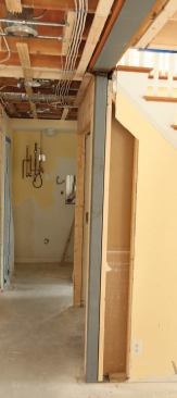 Square hollow-steel posts standing on the slab foundation and welded to the beam provide permanent support.