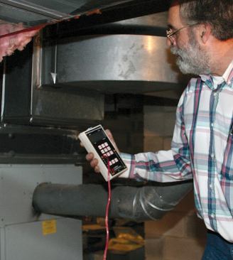 A digital manometer is used to measure the oilfired furnace's draft, or ability to vent combustion gases.