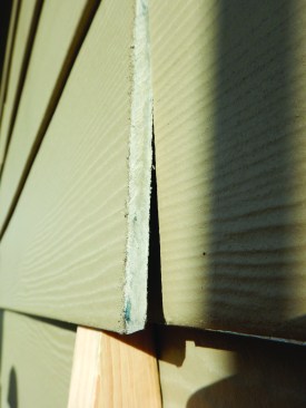 Whoever installed this siding neglected to prime the cut ends - a requirement of the manufacturer's installation instructions, which building codes mandate must be followed.