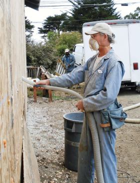 Repairs to an 80-year-old house included dense-pack cellulose insulation blown through outside sheathing.