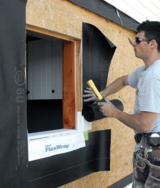 I install paper flush with the jambs, starting several inches above the opening and running it to the bottom of the sill paper.