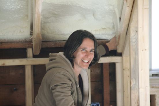 Rachel Conly identifies an air leak at a joint where the roof system meets the wall system during blower door testing.
