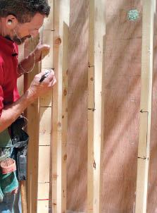 Figure 9. Use a story pole with the tread elevations marked on it to lay out the risers and treads on the frame.