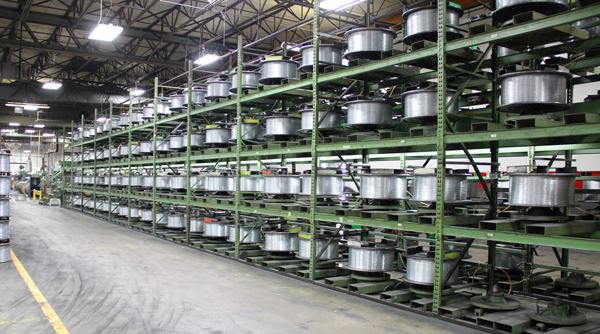 All of this wire (
click here for video) is being fed into a machine that glues them edge-to-edge (gangs them together) into a continuous strip. This “pre-collated” material is later fed into punch presses that stamp it into strips of staples or finish nails.