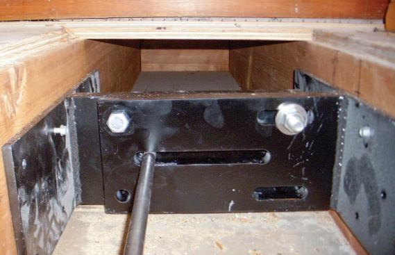 Heavy steel H-brackets installed between the second-story floor joists receive the interior ends of the tie rods.