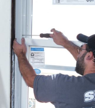 Once I'm confident the frame is plumb, I screw in the adjusting screws located halfway up the sides of the frame, then install the final installation screws.