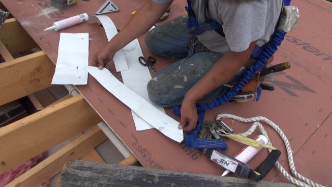 To protect data cabling from damage from the sharp edges of the cut flashing, Phillips bends scraps of flashing over the cut edges at locations where the flashing may touch the wires.