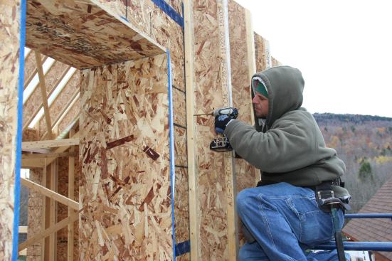 Screwing the upper end of the I-joist into the wall.