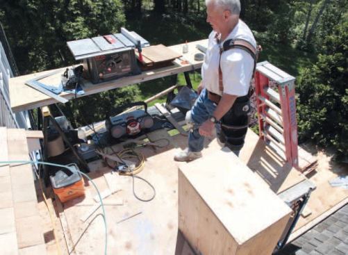 I prep the job by erecting a comfortable work platform at eaves level, atop pipe scaffolding, and then — to minimize ladder trips — set up the tools I need.