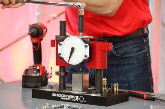 Milwaukee is about to introduce the next generation of Shockwave Impact Duty Driver Bits. The gizmo in this photo was used to demonstrate their qualities versus those of the competition. Bits were placed in the device and twisted to failure with a socket wrench. The dial indicates how much torque it took. Most competing brands broke at the tips rather instead of the thinned out area that’s supposed to flex (what on Milwaukee bits is called the Shockzone). It took much more torque to break the Shockwave bit and when it did break it broke at the Shockzone. How did Milwaukee manage this? They redesigned the alloy and used a longer more involved heat-treating process than in the past. The new bits are available with Phillips, square, Torx, slotted, hex, and ECZ tips. 
Click here for video. Available: September 2015