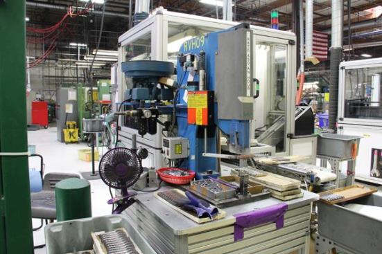 Parts must be positioned in this riveting machine by hand. My tour guide works in the office but as part of her training she had to spend a couple of hours operating this machine (and others) so she would know what she was talking about.