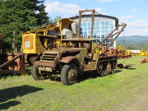 This WWII era half-track was modified for logging and looks to have been used very hard. The piece angling off the back is an A-frame, which was used for lifting. It’s hard to see in the photo but a cable runs through a sheave (pulley) on the A-frame and connects to a winch on the vehicle.