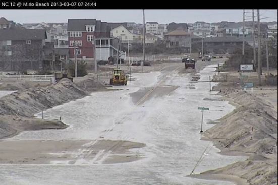 Crews clear sand and water from N.C. 12 on March 7