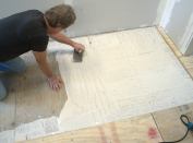 To achieve maximum strength and smoothness, 95 percent to 100 percent of the entire plywood surface must be covered with ANSI Type 1 or 2 waterresistant wood glue. At the perimeter of the floor, to avoid squeeze-over into the movement-joint slot, the author keeps the glue about 1/2 inch from the wall.