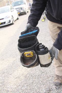 The speed square pouch, which Ryan clips directly to the belt, holds a deep nail bag which holds a shallow nail bag and water bottle holder.