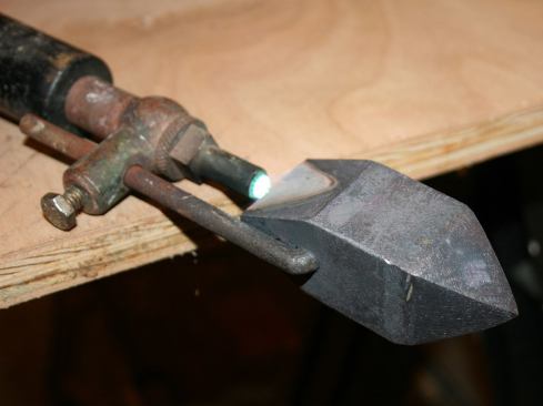 Light the iron and keep it on a low setting so it heats up slowly.