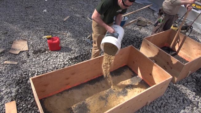 Adding sand to the form.