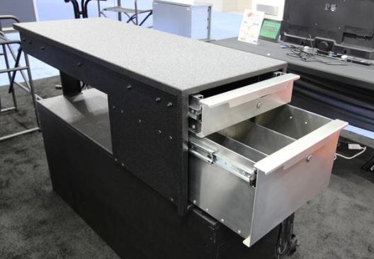 EZSTAK makes aluminium truck-bed drawer units in multiple configurations. This Sidekick is a two-drawer unit that fits over the wheel well; it would typically be paired with an EZSTOW unit that fills the center of the bed. The upper drawer of the EZSTAK extends up to 60 inches and holds up to 500 pounds. The lower drawer is shorter because of the presence of the wheel well. Latching spring-loaded pulls are standard; cylinder locks are optional. The Sidekick is made in Chicago, lists for about $1,800, and is available for Ford, Dodge/Ram, and Chevy/GMC trucks.