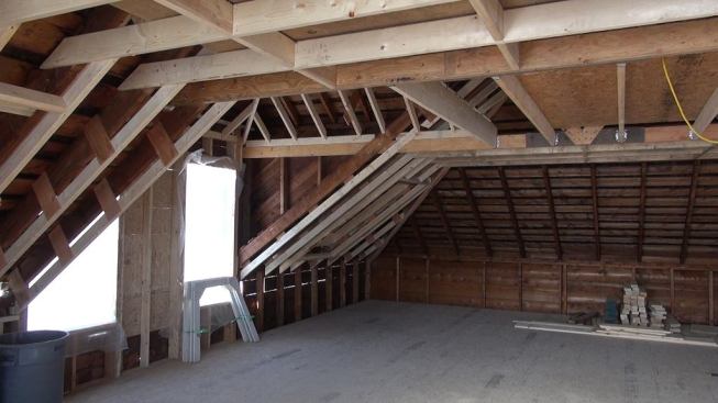 A view of the roof system showing the thickened rafter assembly. The crew attached new 2x4 ceiling members to the existing rafters using plywood gussets, in order to create a deep space for insulation. Later, three inches of spray polyurethane will be applied to the underside of the roof, and the remaining cavity will be filled with dense-blown cellulose.