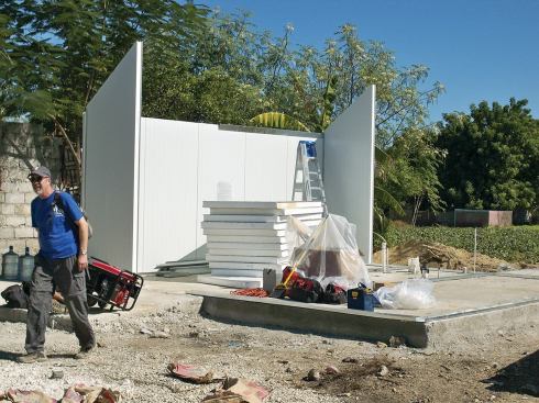 The panels have a T&G friction-fit edge profile and attach to each other and to the galvanized metal base track with screws. The cottage was erected on the existing concrete foundation of a home destroyed by the 2010 earthquake.