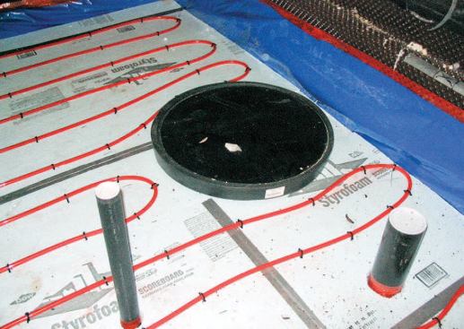 Before installing the slab's poly vapor barrier and 2 inches of rigid foam insulation, we trenched and plumbed the new basement sump.