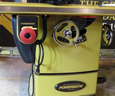 There are a few things of note in this photo. To turn the motor on, push the button in the middle of the donut-shaped switch. Turning it off is a matter of pressing the red part of the switch, which in a pinch can easily be done with a hip, leg, or knee. The yellow piece above the “donut” is a safety that can be removed to prevent unauthorized use of the machine. Note the heavy steel hand wheels and the 115-volt plug on the end of the cord. If 230-volt power is available the saw can be converted to that voltage by switching some jumpers inside the motor and changing the cord.