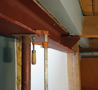 Once the beam was positioned and checked for level with a line laser, the crew set up post shoring for temporary support.