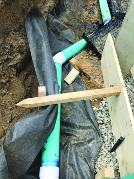 Note that the holes in the drainpipe face down to limit the volume of water that accumulates at the footing.