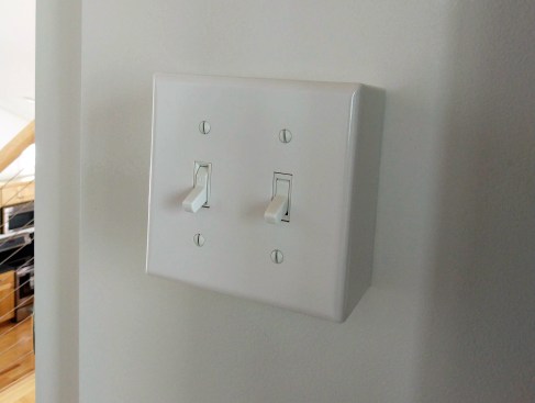 The surface-mount wall switch is an example of a fixture on an exterior wall that avoids wall penetrations.