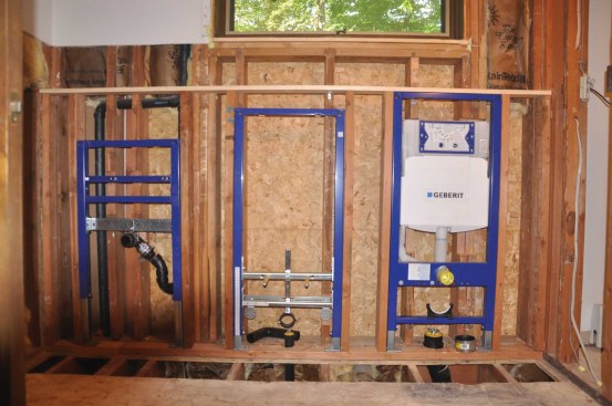 The sink, toilet, and bidet are supported by Geberit (geberitnorthamerica.com) steel carriers bolted to the framing. The carriers require 20 inches between studs and a 5 1/2-inch depth for the toilet’s water tank. To get the needed spacing and depth, the author built a 2x4 wall, 48 inches high, in front of the existing wall. This created a 3 1/2-inch shelf above the fixtures.