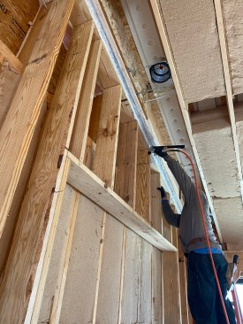 On a different job, insulated mostly with batts, the crew needed to staple the membrane over odd cavities unsuited to batt.