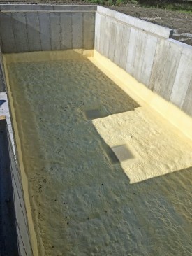 The foam is brought up the wall a good 12 to 16 inches to get it well above the slab surface to tie in with the wall insulation and ensure a continuous air-seal.