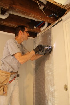 Then I covered it with wire lath, securing the lath with screws and plaster washers.