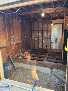 At the end of demolition, the old porch framing had been removed, and only the original framing of the main floor remained.