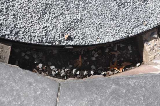 However, this edging had to be reset to match the new surface elevation.