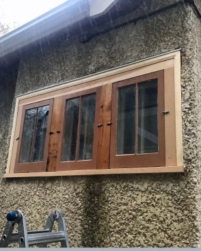After rebuilding the window, the author advised the owner to move this outlet (and replace it with an exterior-rated GFCI unit). In this photo, the outlet has not been moved but the wire is gone for the time being.