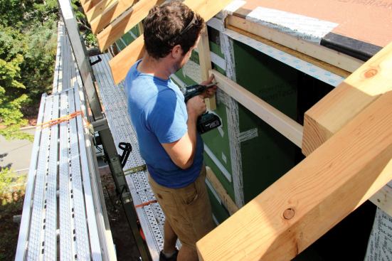 Before the windows are set (Placetailor is using European-made, triple-glazed Schuco tilt-and-turns), temporary 2x3 rails are fastened across the window opening to serve as positive stops that hold the window flush with the wall sheathing.