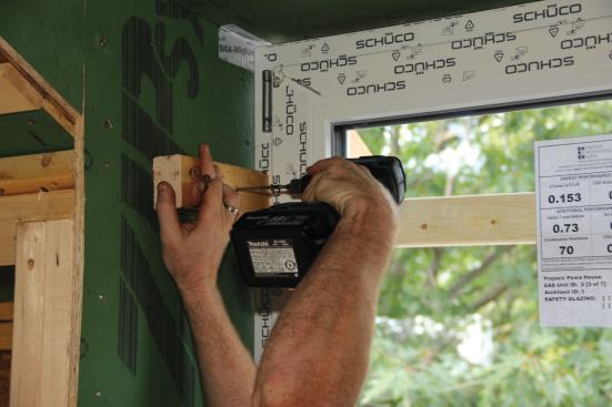 ... where it is secured with two temporary blocks screwed top and bottom to the window buck side jambs.