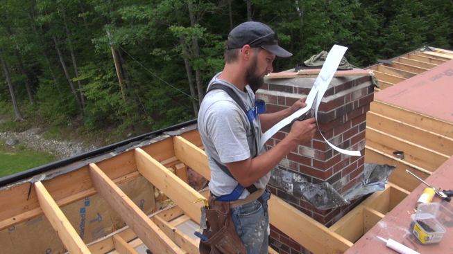 Phillips trims a piece of flashing to width using Cutco hardened steel shears.