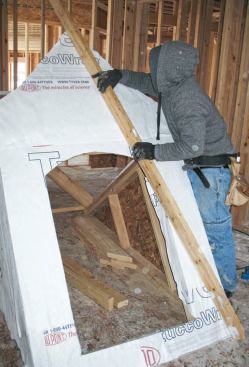 Ridge: We placed a straightedge across the front face of the dormer to make sure there was no deflection in the hinge joint at the top plate.