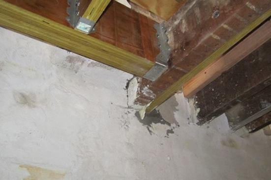 On the right side of the new framework that works around an existing chimney, the new LVL member has been bolted to an existing 3x10 sawn floor joist, and bedded into the brick wall alongside the existing member. Project engineer Kathy Dunne says the existing brick structure is more than adequate to handle this kind of new point load, as long as it’s repaired and repointed where necessary. Non-shrinking grout is used to embed the new framing into the walls.