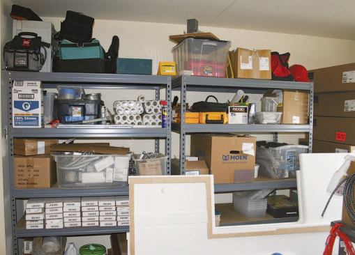 A desk and storage shelves for project supplies were set up the living room.