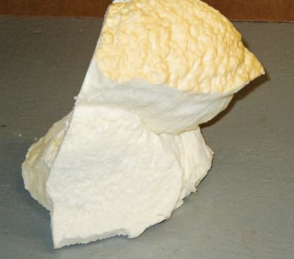 The obvious "hourglassing" in this larger chunk of foam indicates that the center of the freshly applied material was allowed to grow too hot. Though it was apparently stable for months after application, the onset of cold weather caused the foam to shrink and break apart.