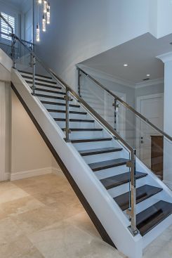 The client was so impressed with the high gloss finish and pattern found on the kitchen island, BJ Barone of 41 West used the same material for the stairs. The marriage of the ebony steps with the glass and chrome rail offers the perfect blend of materials to achieve an elogant yet masculine feel.