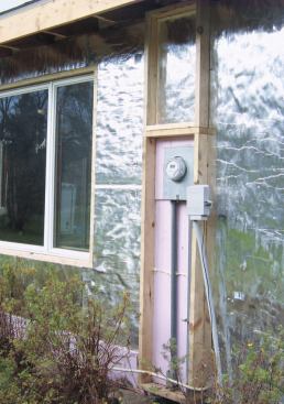 Rather than go to the expense of moving the electric meter away from the wall to accommodate the full thickness of the polyiso board, the crew boxed in the area around the meter and filled it with a thinner layer of XPS.