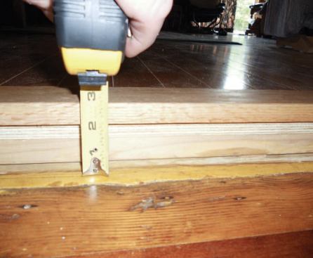 Including the insulation, the finished floor, consisting of 1/2-inch plywood and 5/8-inch prefinished oak, raised the room’s threshold by almost 3 inches. A gently sloped transition was added later.